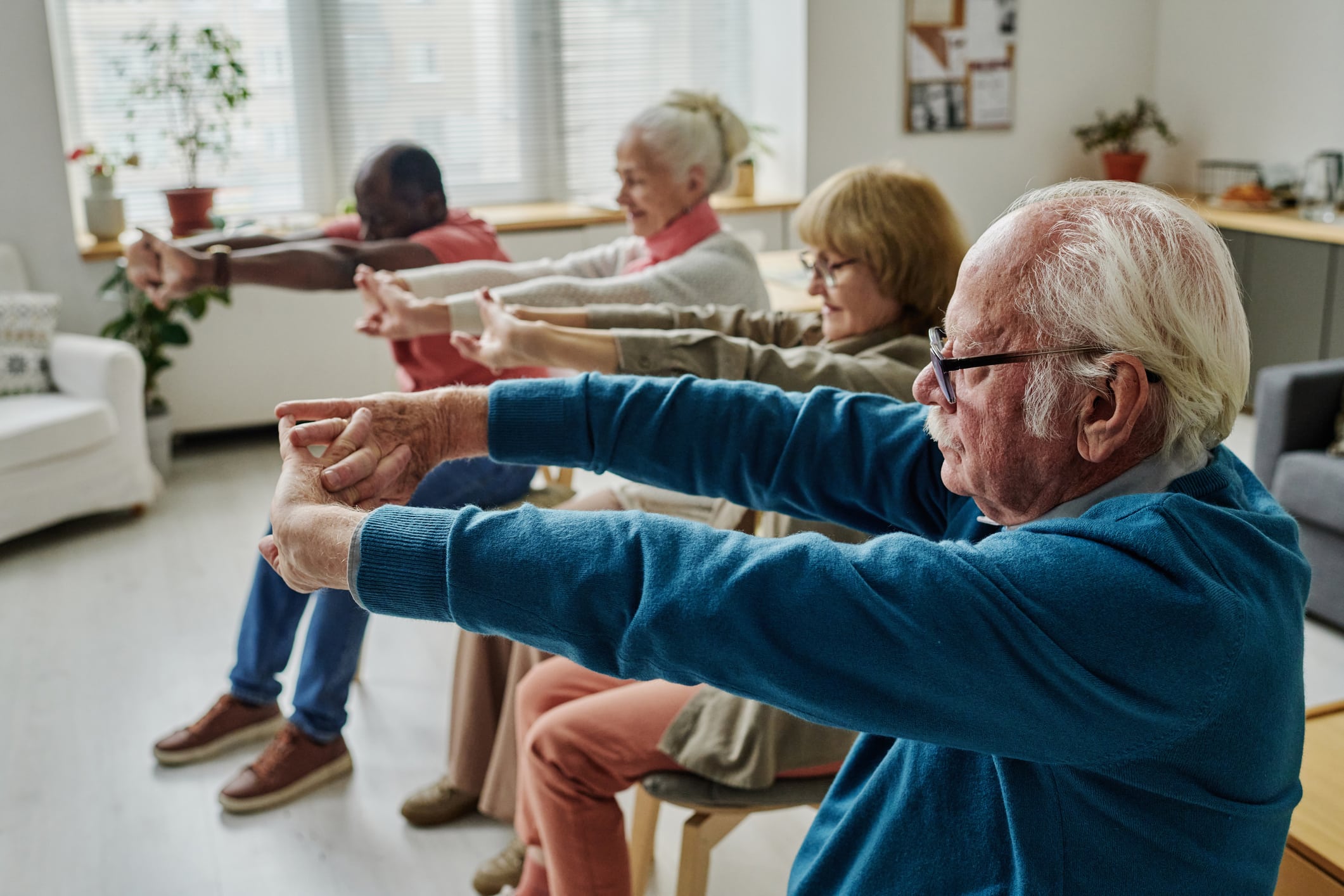Multiple people doing chair exercises for seniors.