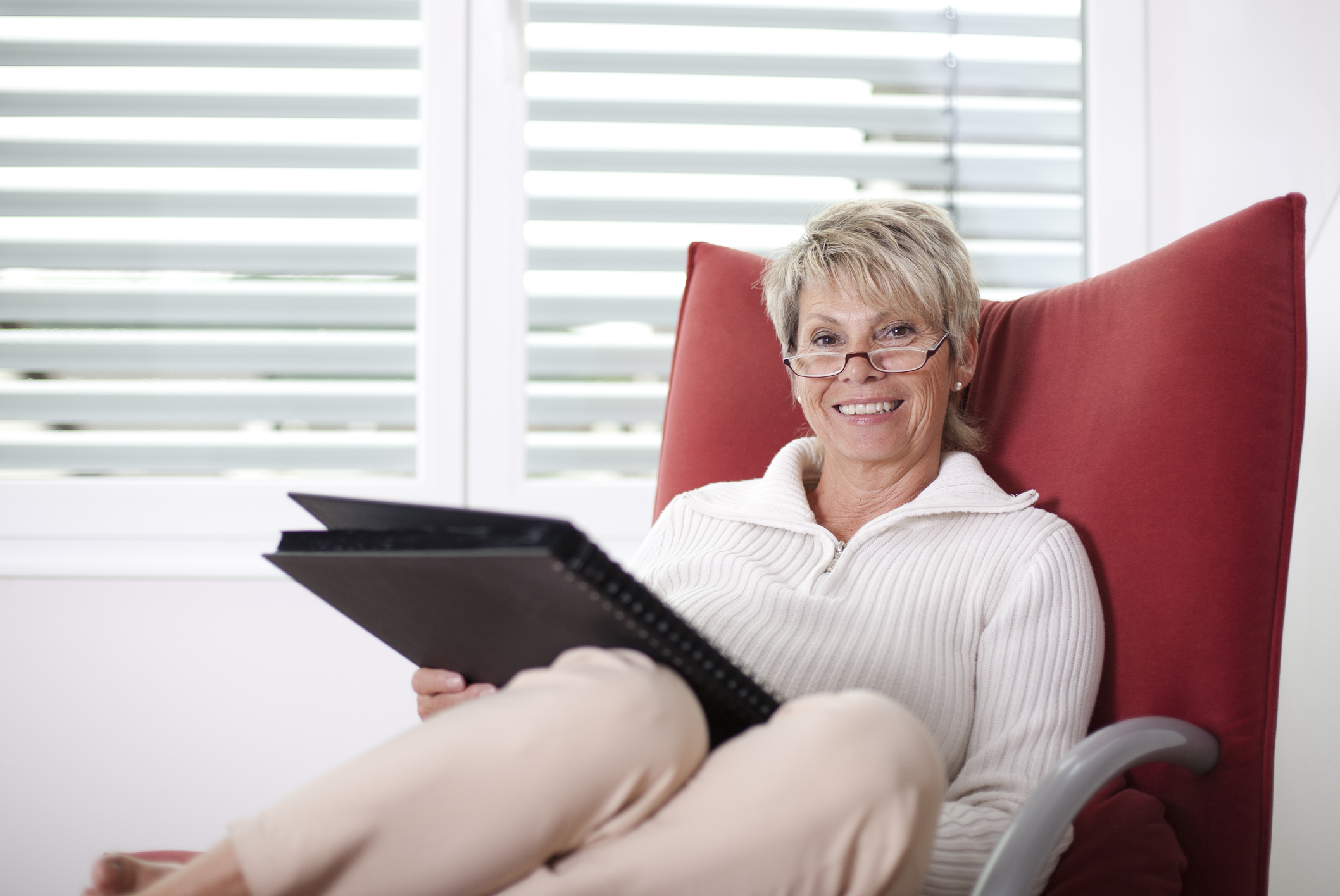 An older adult holding a senior emergency binder containing important documents.